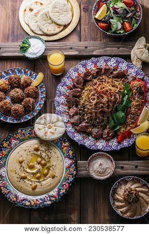 Middle Eastern Or Arabic Dishes And Assorted Meze On A Dark Background.