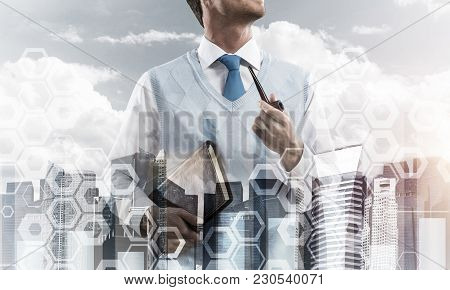 Double Exposure Of Confident And Young Businessman In Smart-casual Wear Smoking Pipe And Modern City