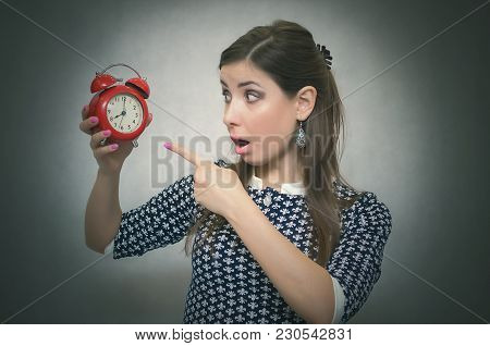 Overslept Shocked Woman Holding In Hand A Red Alarm Clock. Be Late At Work Or School. Oversleep. Lat