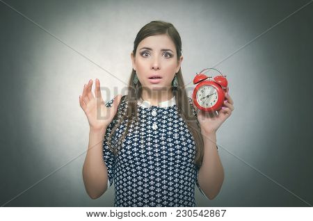 Overslept Shocked Woman Holding In Hand A Red Alarm Clock. Be Late At Work Or School. Oversleep. Lat