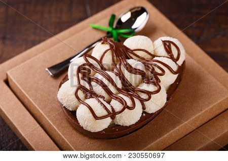 Chocolate Egg Ith Filling For Easter On Wooden Background
