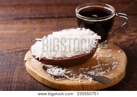 Chocolate Egg With Filling For Easter On Wooden Background