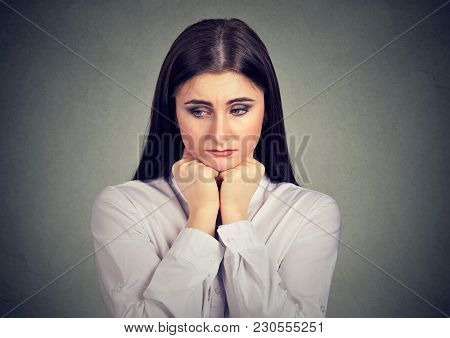 Pretty Young Woman Looking Down In Expression Of Misfortune And Sadness.
