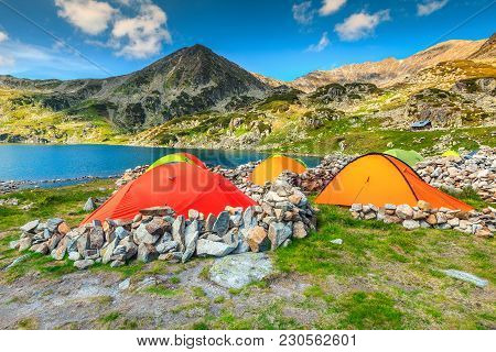 Wonderful Alpine Camping Place With Colorful Tents Near Bucura Glacier Lake. Stunning Mountain Campg