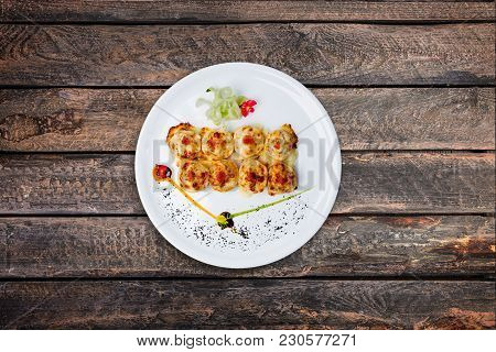 Sushi Philadelphia Royal Served On The White Plate With Wooden Background, Top View. Japanese Food.