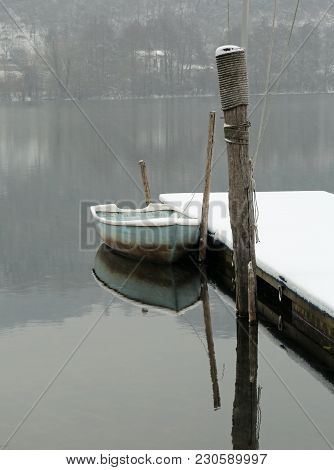 Single Boat On The Lake In Winter With Snow