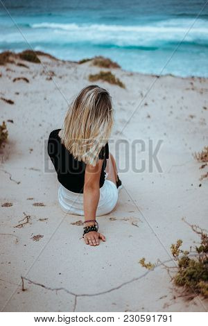 Woman Sitting In White Sand Dune Admiring Coastline Andscape And Waves Of Atlantic Ocean. Sao Vicent