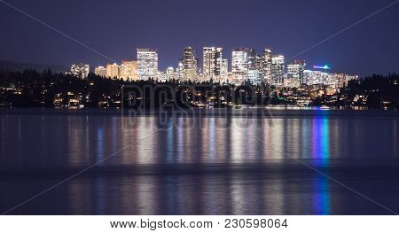 Fast Growing Bellevue Washington City Light Reflecting In The Water View From Across The Lake