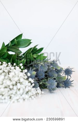 Blue Flowers Eringium And Gypsophila  On A Close-up Table