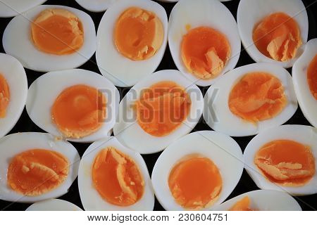 Halfs Of Hard Boiled Free-range Eggs On A Black Plate