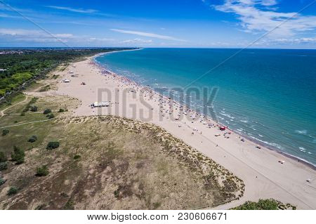 Italy, the beach of the Adriatic sea. Rest on the sea near Venice. Aerial FPV drone photography.
