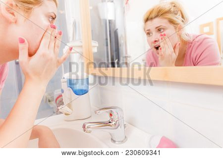 Sensitive, Dry Skin Problems Concept. Scared Woman Washing Her Face Under Sink.