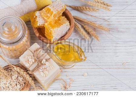 Honeycomb, Sea Salt, Oats And Handmade Soap With Honey On White Rustic Wooden Background. Natural In