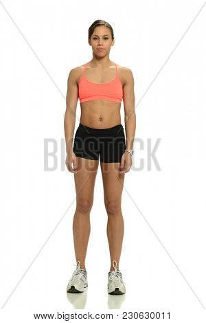 Woman athete standing isolated on a white background