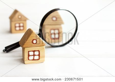 Wooden Houses And Magnifying Glass For Inspection / Thorough Study Of Real Estate Offers