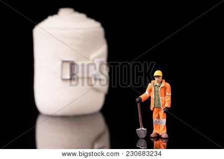 Bandage Used For Injuries During Work, Leisure Time Or In Housework, Isolated On Glossy Black Backgr