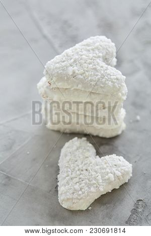 Sweet Crunchy Coconat Heart-shaped Biscuits Arranged In Pattern On Light Textured Background, Top Vi