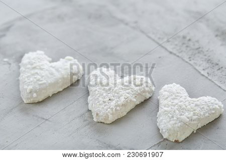 Sweet Crunchy Coconat Heart-shaped Biscuits Arranged In Pattern On Light Textured Background, Top Vi