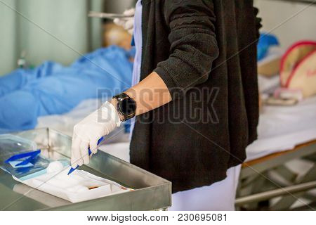 The Nurse With Lots Of Medicine Is Preparing Or Cleaning The Stitch Of Her Woman Patient After Surge