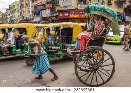 Kolkata, India - April 5, 2017: Traditional hand pulled indian rickshaw driver working on the street in Kolkata, West Bengal, India