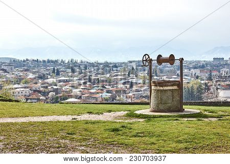 Retro Old Well On The Background Of The City Panorama. Kutaisi, Georgia. Europe. Travels. Nature