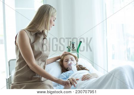 Woman Takecare Girl Sleeping With Respiratory Mask Equipment In Hospital. Healthcare And Medical Con