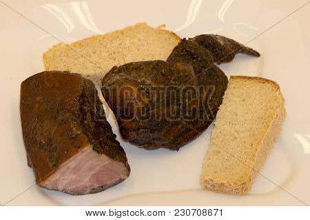 Grilled Pork Meat On A White Plate, A Shish Kebab From Pork On A Black Background,next To The Bread