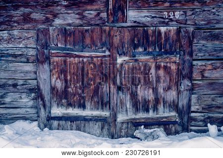 Doors of an old barn on a cold winter morning in the beautiful town of Zinal, Switzerland. These typ