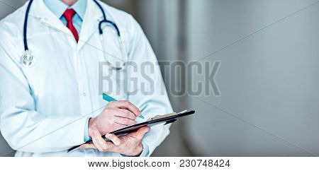 The Doctor Writes Out The Prescription At The Hospital