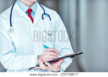 The Doctor Writes Out The Prescription At The Hospital