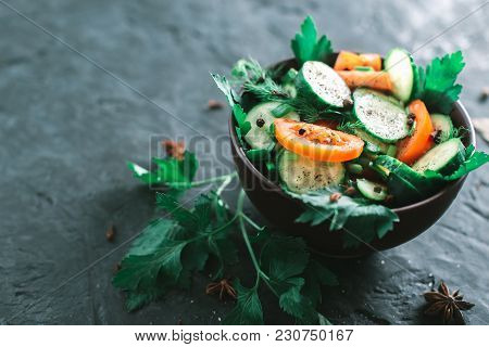 Fresh Salad With Vegetables On A Black Matte Background. The Concept Of A Healthy Diet.