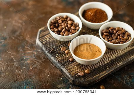 Set Of Coffee Beans, Ground Coffee And Instant Coffee In White Bowls