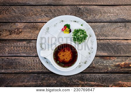 Miso Soup In A White Ceramic Bowl, Served On The White Plate And Wooden Background. Top View.