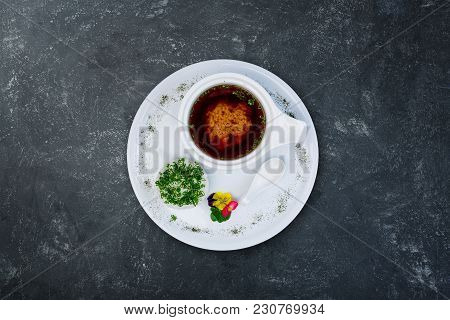 Miso Soup In A White Ceramic Bowl, Served On The White Plate And Grey Plastered Background. Top View