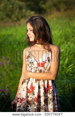 The Young Beautiful Girl, With A Bouquet Of Flowers, Has A Rest And Enjoys Beauty Of The Nature In T