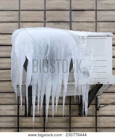 The External Unit Of The Air Conditioner Is Covered With Large Icicles. Incorrect Use Of The Air Con
