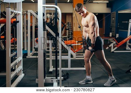 Man Doing Cable Fly Exercise In Gym