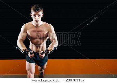 A Young Man Does Hand-cutting On The Simulator In The Gym. Exercise For The Muscles Of The Chest. Cr