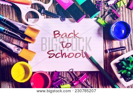 Ack To School Background With School Supplies On Wooden Background.