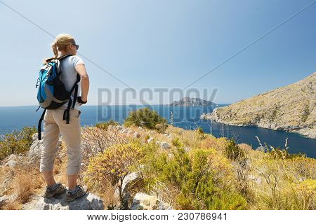 Woman With Bag Stand At Top Of Mountain