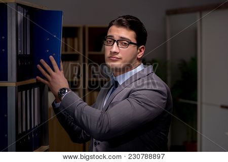 Businessman almost falling asleep working late hours in the offi