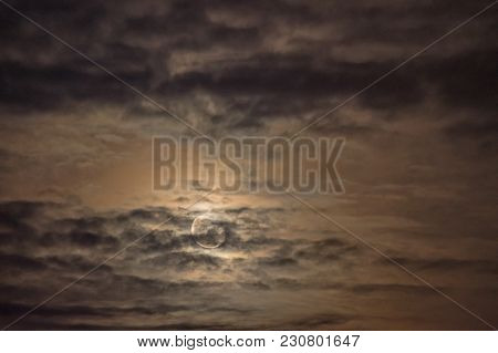 Moon In A Cloudy Sky.
Night, Slightly Cloudy Sky. The Clouds Are Arranged In Parallel Layers. Behind