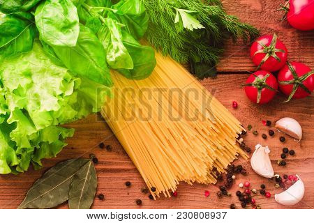 Cooking Italian Pasta Spaghetti With Fresh Tomatoes Cherry, Greenery Basil And Spices - Messy Top Vi