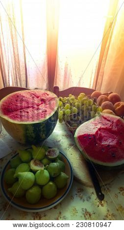 Cut Juicy Big Watermelon With Heart Summer Fruits Figs Grapes And Peaches On A Kitchen Floral Table 