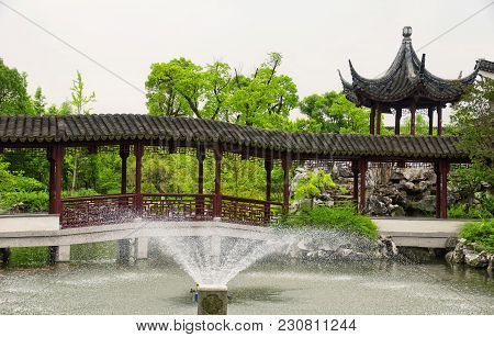 A Water Fountain And Covered Corridor At The Classical Chinese Li Yuan Garden In Zhaojialou In Shang