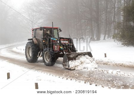 Drewsteignton, United Kingdom, 3rd March 2018:- A Tractor Clears Snow From A Roadway After The Beast