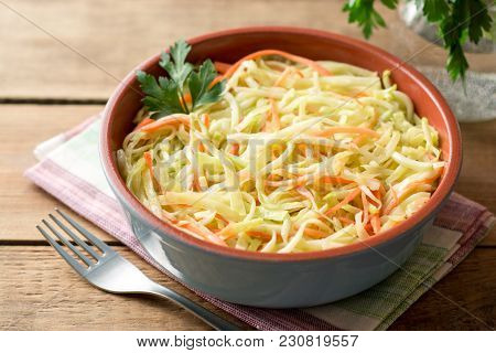Fresh Coleslow Salad In Bowl On Rustic Wooden Table