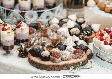 Candybar In A Restaurant. Decorated White Table Fool Of Sweet Pastry. Wedding Sweets.