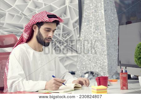 Arabian Business Man Working On Laptop In The Office.