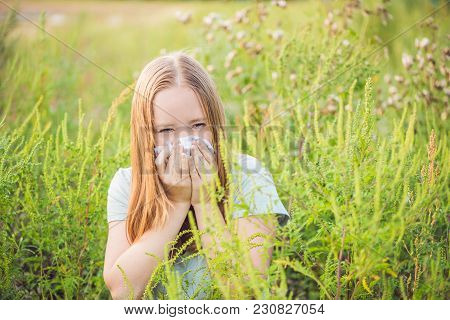 Young Woman Sneezes Because Of An Allergy To Ragweed.